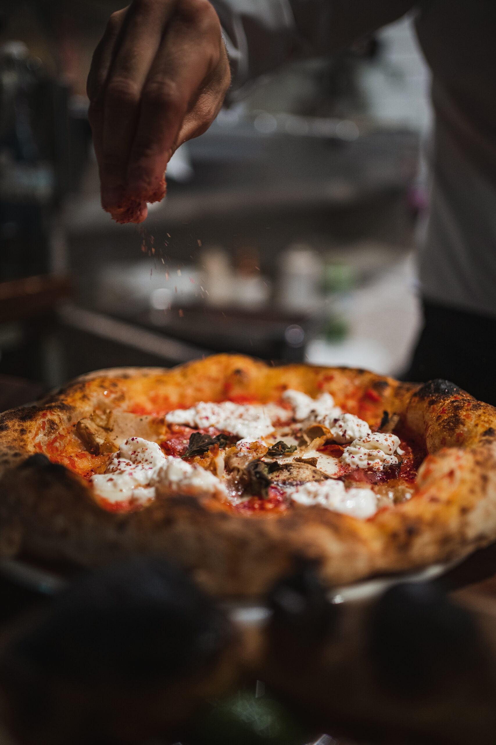 Cook,Finishing,Of,Preparing,A,Delicious,Pizza,In,Italian,Restaurant