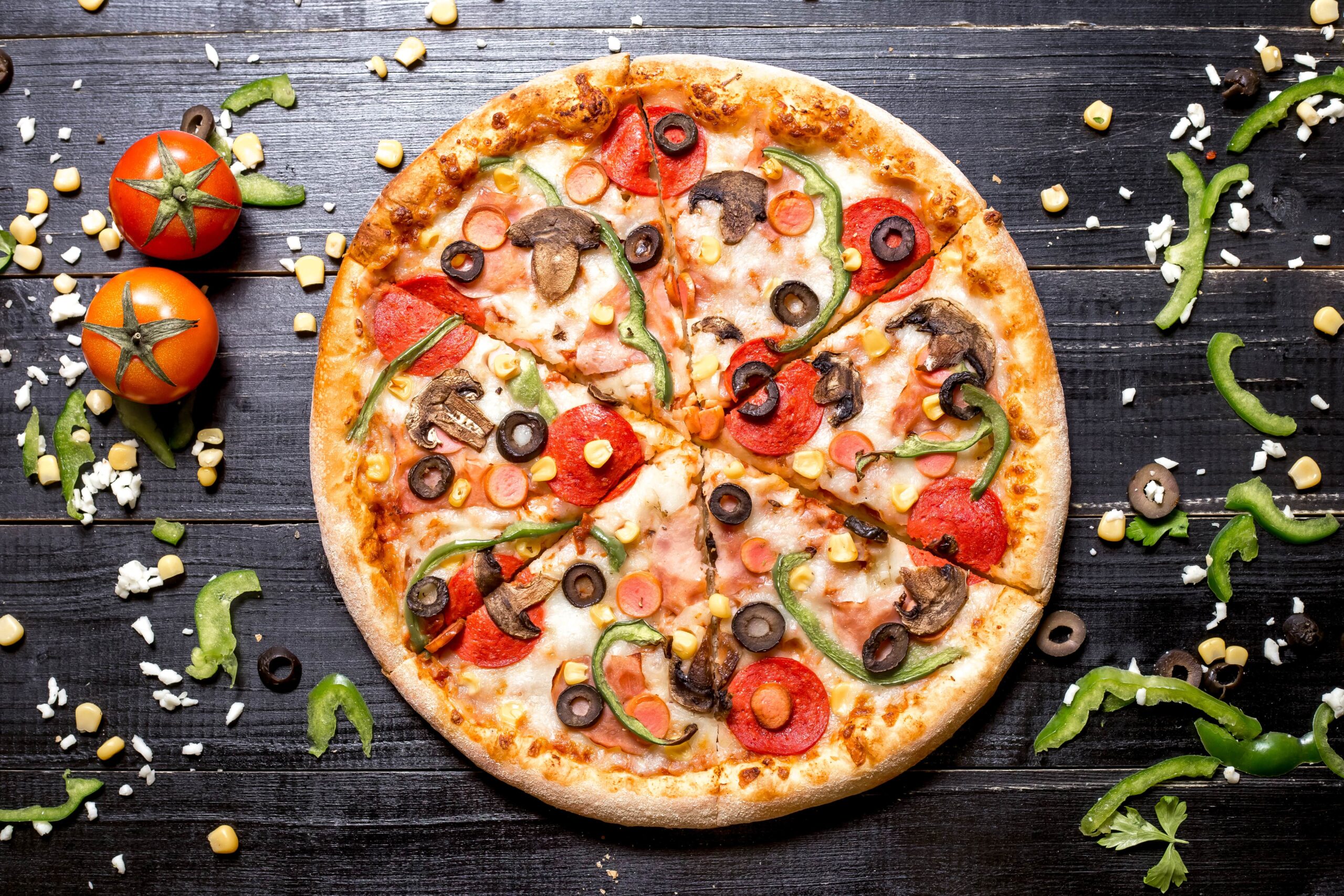 top-view-pepperoni-pizza-with-mushroom-sausages-bell-pepper-olive-corn-black-wooden-min